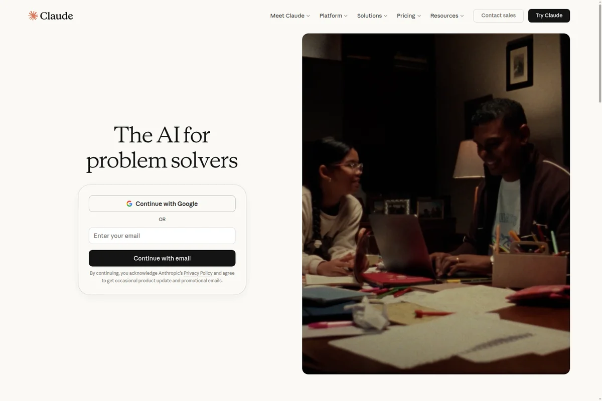 Claude homepage hero section showcasing a user sign-up form and a photograph of two individuals collaborating on a laptop.