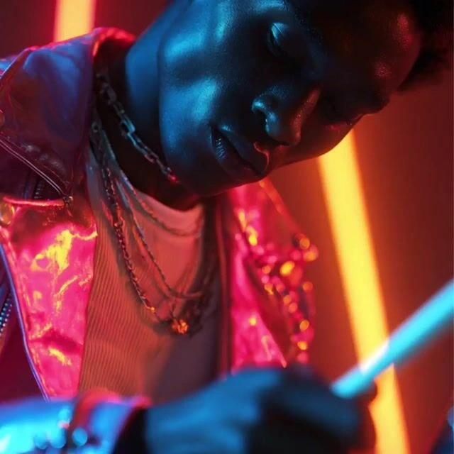 Domo AI backup generated portrait showing a person in a neon-lit, stylish setting with a dark aesthetic.