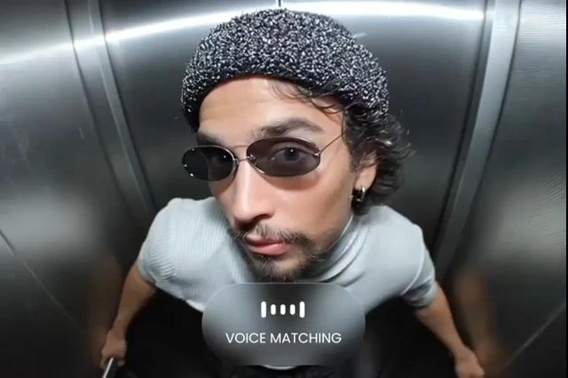 Domo AI Backup voice matching feature demonstration in an elevator with a user looking at the camera and an on-screen overlay.