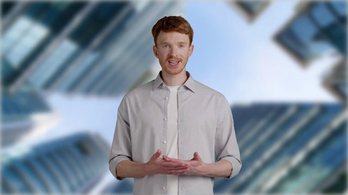 Fliki generated video output showing a male AI presenter against a blurred modern office background, demonstrating high visual quality.