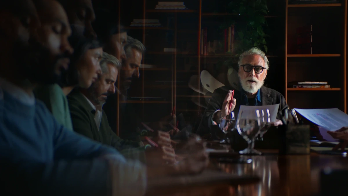 Harvey professional consultation showing a senior expert discussing documents with a diverse team in a warm, dynamic setting.