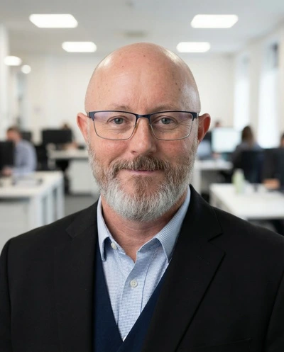 HeadshotPro generated output showing a professional male headshot with a blurred office background.