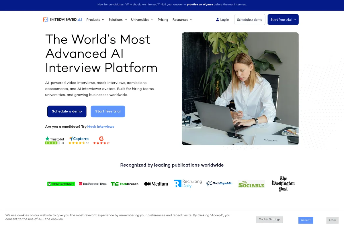 Interviewer AI homepage hero section featuring its advanced AI interview platform and a professional woman using a laptop.