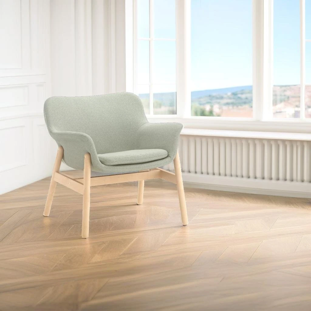 Pebblely output sample showing a minimalist armchair in a sunlit room with a modern aesthetic.