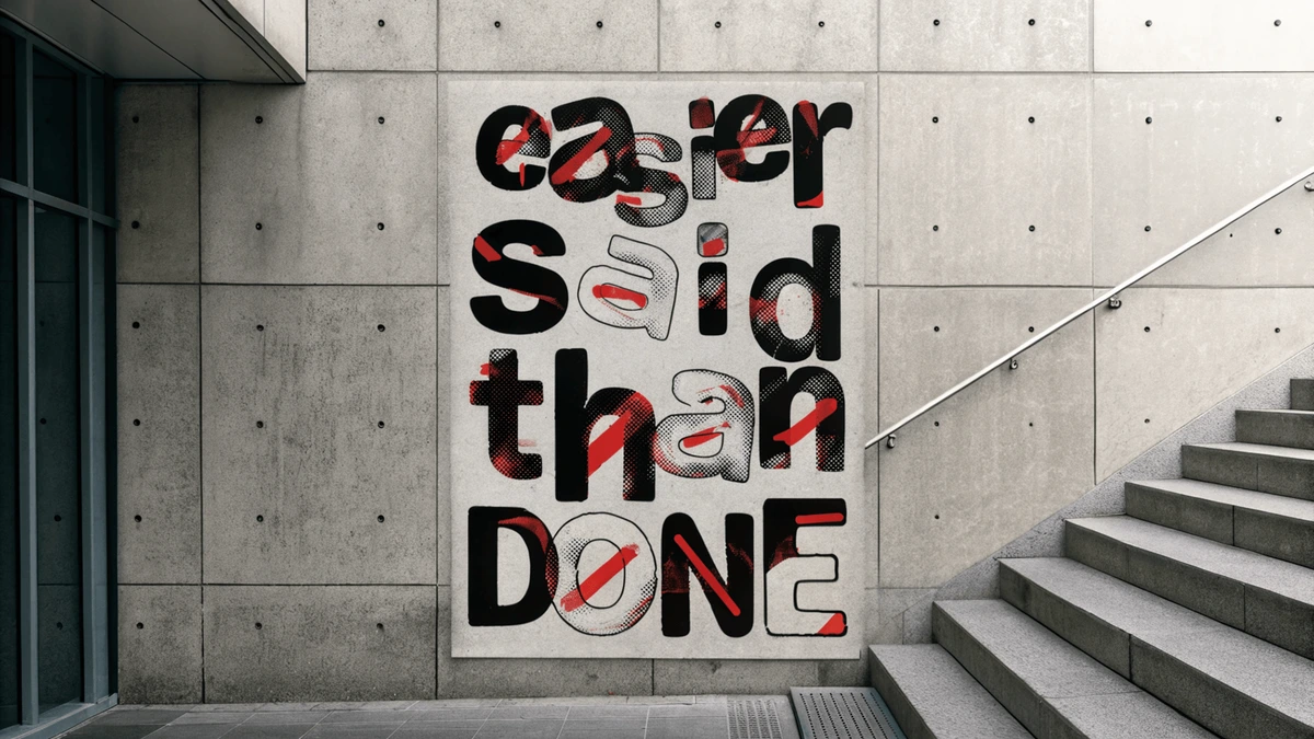 Recraft landing page hero image featuring a bold graphic poster with 'easier said than done' in a striking, distressed red and black typeface on a concrete wall.