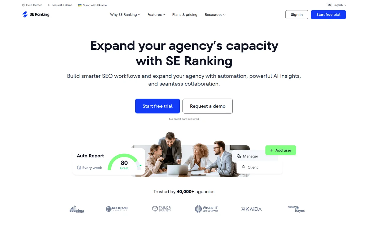 SE Ranking landing page hero section showing a team collaborating around a laptop with product UI elements for auto reports and user management.