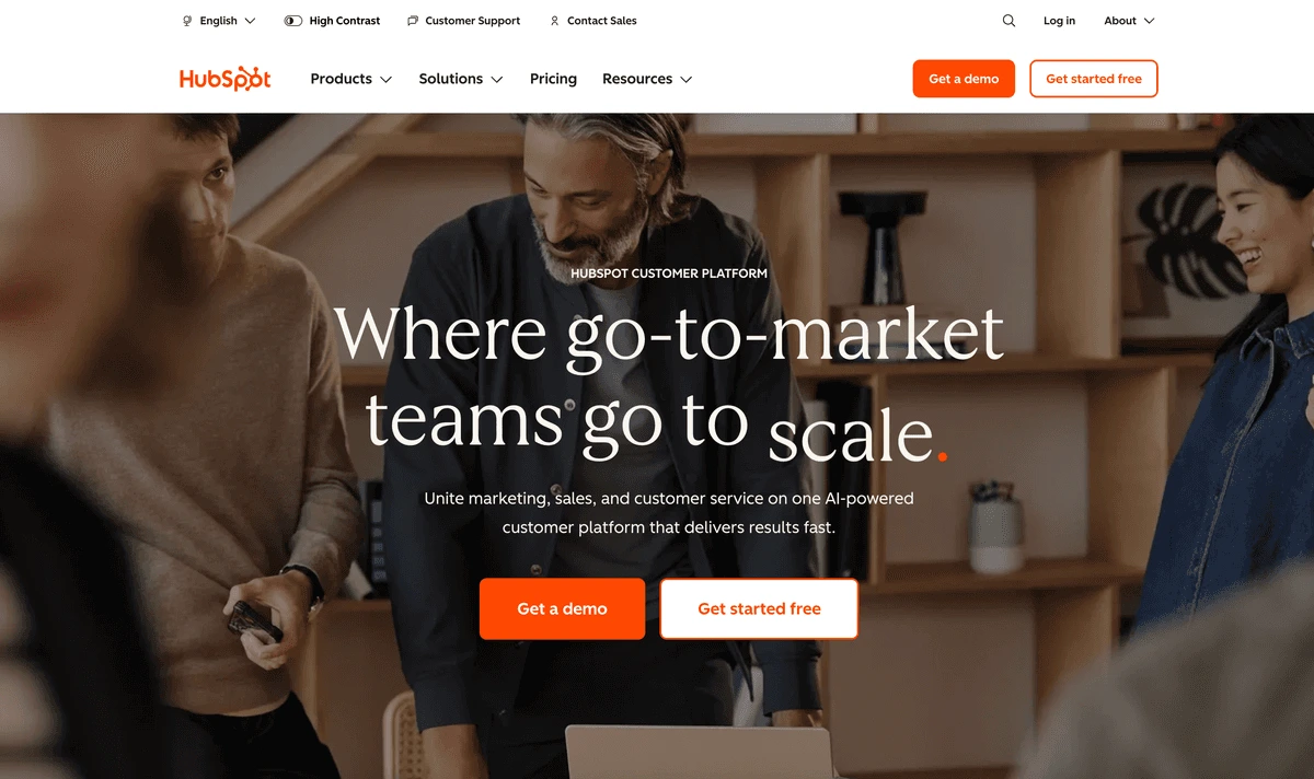 HubSpot landing page hero section showing a diverse team collaborating with a modern, professional interface.