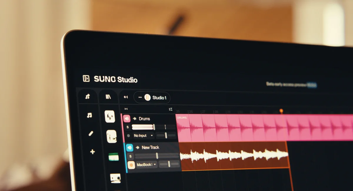 Suno Studio music production workspace showing audio tracks with pink drum waveforms and a dark-mode sleek interface.